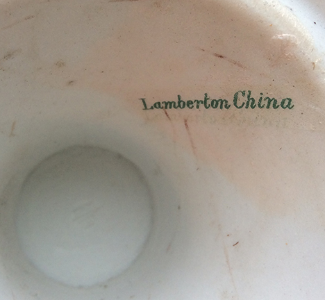 Decal manufacturer’s mark on a footed plate or similar vessel. “Lamberton China” Note rectangular discoloration of residue of the decal application. Base diameter: 3.25”